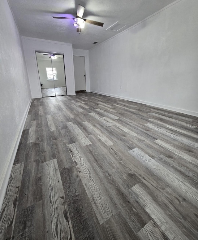 empty room with a textured ceiling and hardwood / wood-style flooring