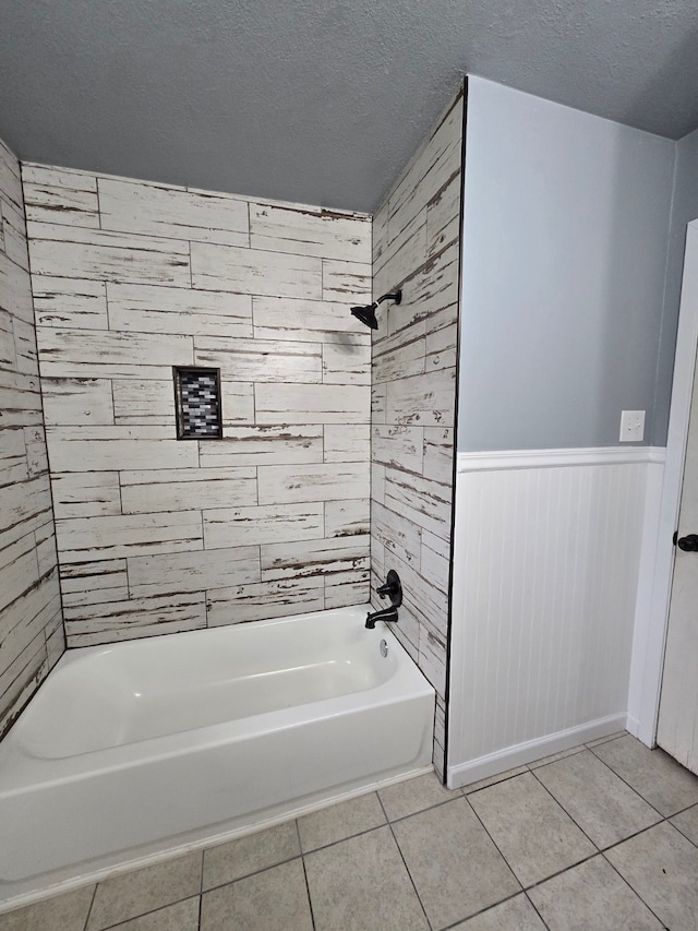 bathroom with tile patterned flooring, a textured ceiling, and tub / shower combination