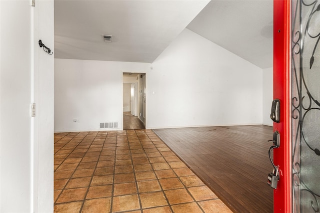 entrance foyer with hardwood / wood-style flooring and vaulted ceiling