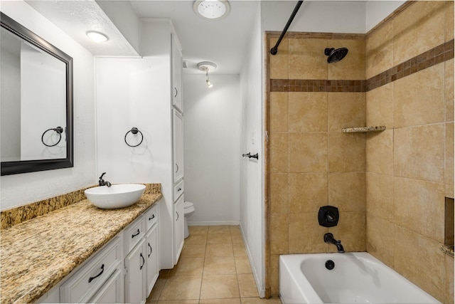 full bathroom with tiled shower / bath combo, vanity, tile patterned flooring, and toilet