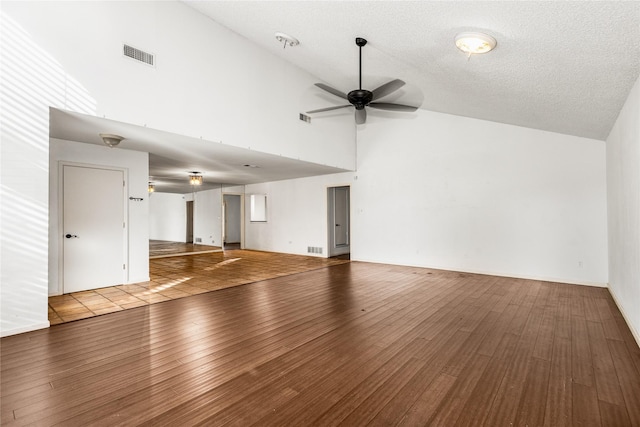 unfurnished living room with high vaulted ceiling, hardwood / wood-style flooring, a textured ceiling, and ceiling fan