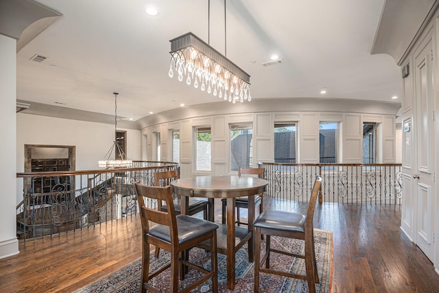 dining room featuring dark wood-type flooring and a notable chandelier