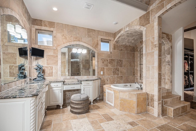 1714 Maranatha Way, Southlake, TX 76092 - full bath featuring stone tile flooring, tile walls, vanity, a garden tub, and recessed lighting
