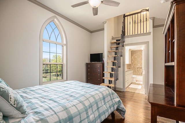 bedroom featuring ornamental molding, ensuite bathroom, ceiling fan, and dark hardwood / wood-style flooring