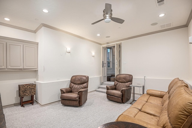 living room featuring light carpet, ornamental molding, and ceiling fan