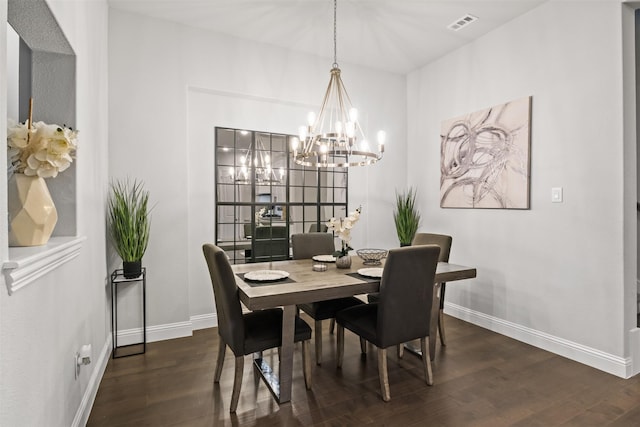 dining room featuring dark hardwood / wood-style floors and a chandelier