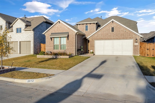 view of front of house with a garage and a front lawn