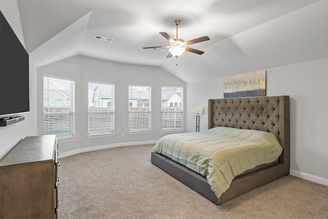 carpeted bedroom with multiple windows, ceiling fan, and lofted ceiling