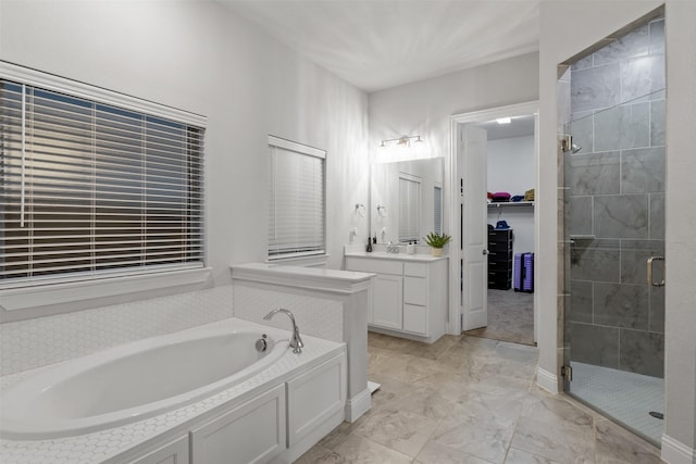 bathroom featuring vanity and independent shower and bath