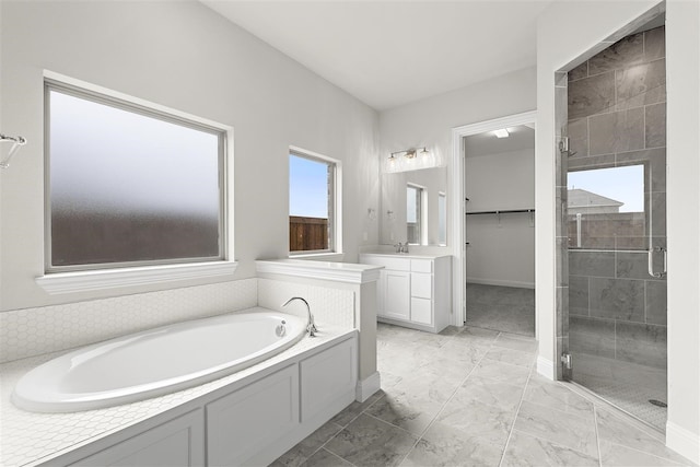 bathroom featuring vanity and separate shower and tub