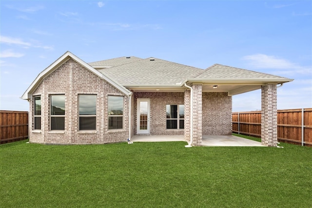 rear view of property with a patio area and a lawn