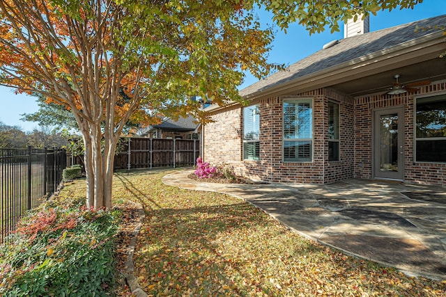 view of yard with a patio and ceiling fan