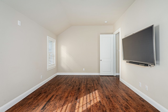 interior space featuring dark hardwood / wood-style flooring and vaulted ceiling