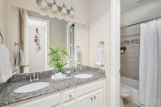 full bathroom with shower / tub combo with curtain, vanity, and toilet