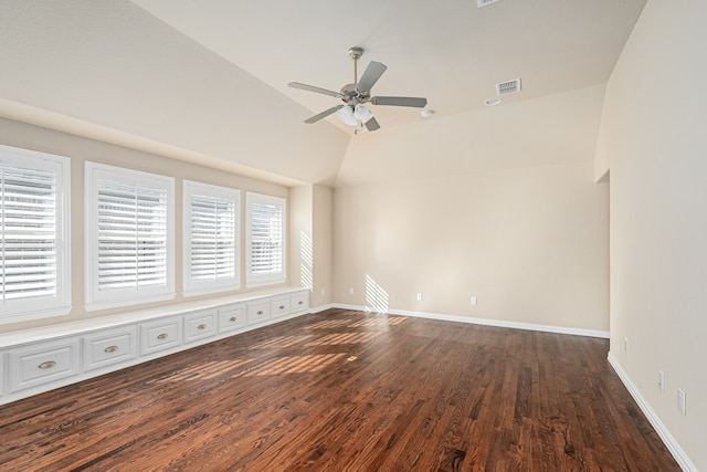 empty room with dark hardwood / wood-style floors, ceiling fan, and lofted ceiling