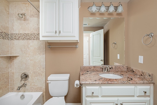 full bathroom with toilet, vanity, and tiled shower / bath