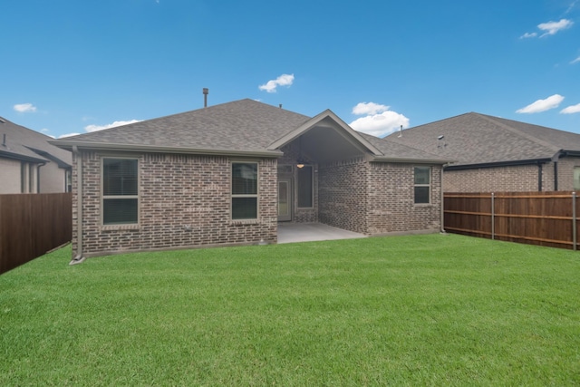 rear view of property featuring a patio area and a yard