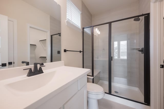 bathroom with vanity, toilet, and walk in shower