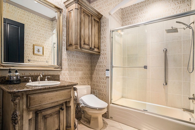 full bathroom featuring tile patterned floors, toilet, shower / bath combination with glass door, vanity, and ornamental molding