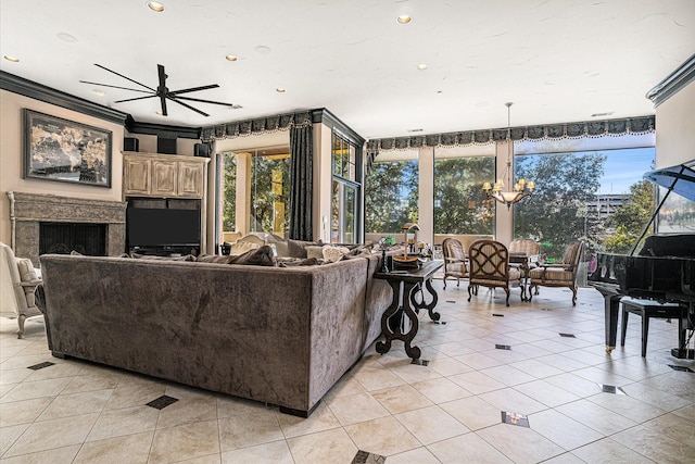 living room featuring ornamental molding, ceiling fan with notable chandelier, and light tile patterned floors