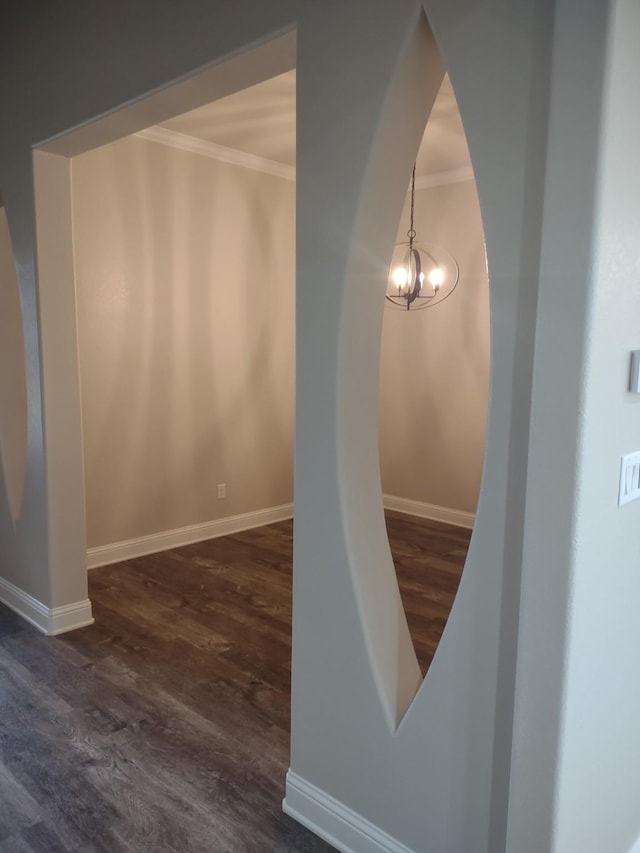 stairway with crown molding, an inviting chandelier, and hardwood / wood-style flooring