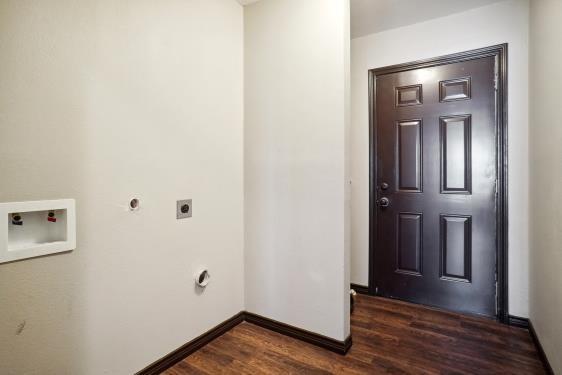 laundry area featuring hookup for a washing machine, dark hardwood / wood-style floors, and electric dryer hookup