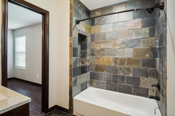 bathroom with vanity and tiled shower / bath combo