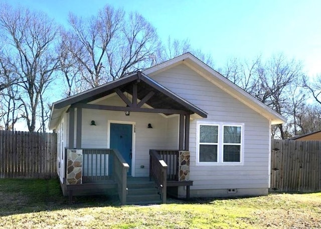 bungalow-style house with a front lawn