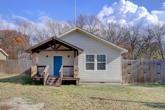 back of property featuring a yard