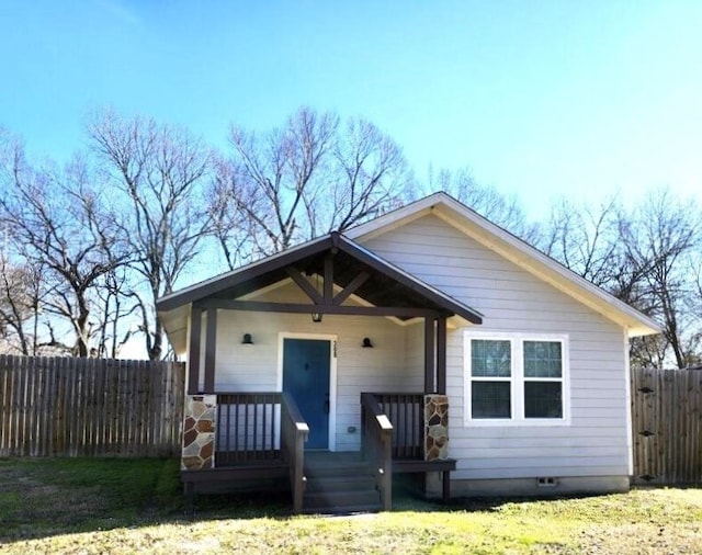 bungalow-style home with a front yard