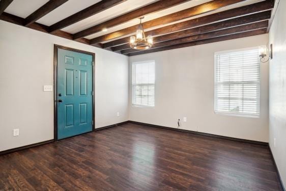 foyer featuring a notable chandelier, beamed ceiling, and dark wood-type flooring