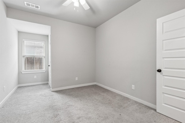 empty room with carpet flooring, baseboards, visible vents, and ceiling fan
