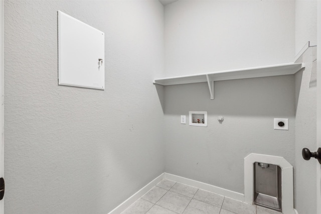 clothes washing area featuring hookup for a washing machine, light tile patterned floors, hookup for an electric dryer, laundry area, and hookup for a gas dryer