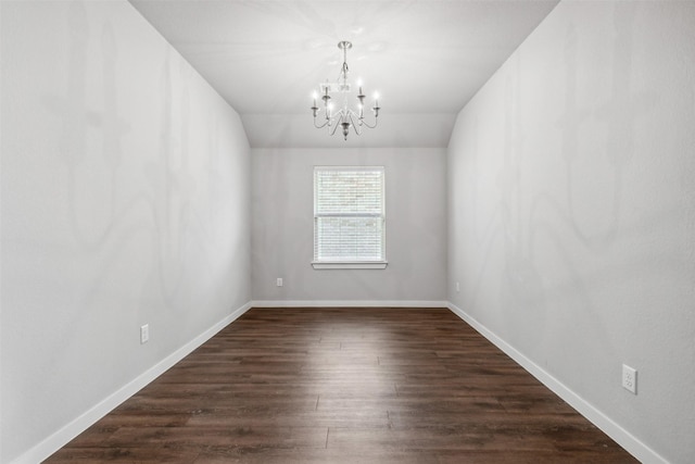 empty room with an inviting chandelier, baseboards, dark wood-style flooring, and lofted ceiling