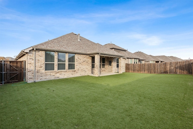 back of property with a patio and a lawn