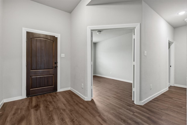 entryway with baseboards and dark wood-style flooring