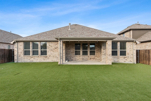 rear view of house with a yard and a patio area