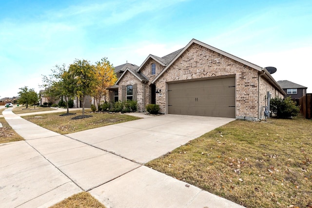 view of front facade with brick siding, an attached garage, concrete driveway, and a front yard