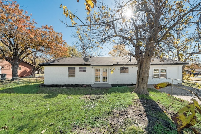 view of front of property featuring french doors and a front lawn