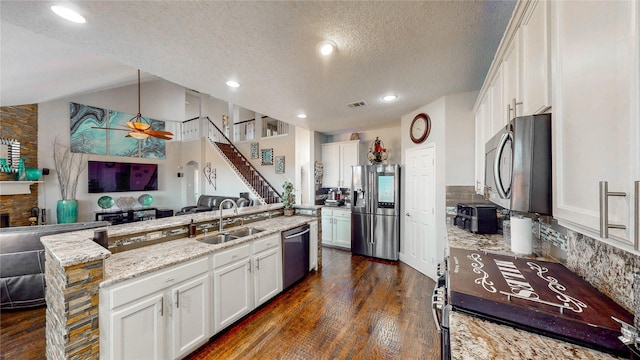 kitchen with white cabinetry, sink, hanging light fixtures, a textured ceiling, and appliances with stainless steel finishes