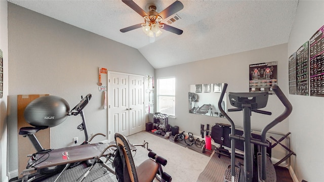 workout area with carpet flooring, ceiling fan, a textured ceiling, and vaulted ceiling