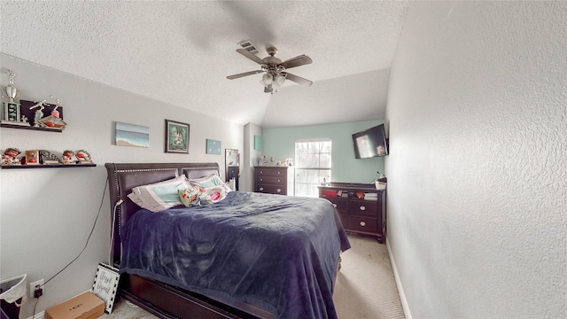 bedroom featuring a textured ceiling, ceiling fan, light colored carpet, and vaulted ceiling