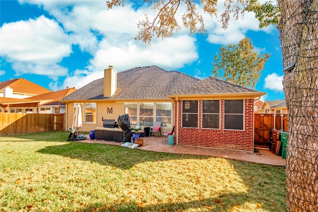 rear view of property with outdoor lounge area, a patio area, and a yard