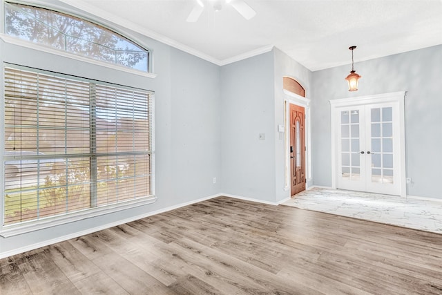 interior space featuring crown molding, french doors, ceiling fan, and hardwood / wood-style floors