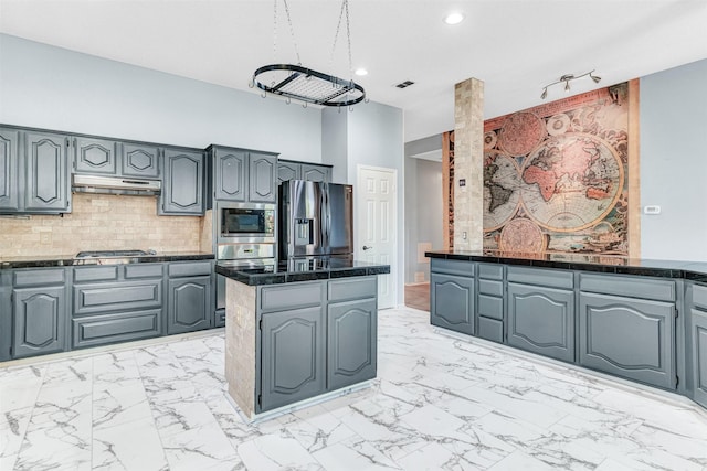 kitchen with tasteful backsplash, gray cabinetry, and appliances with stainless steel finishes