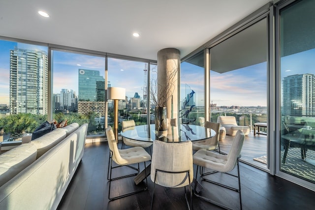 dining area with floor to ceiling windows and dark wood-type flooring