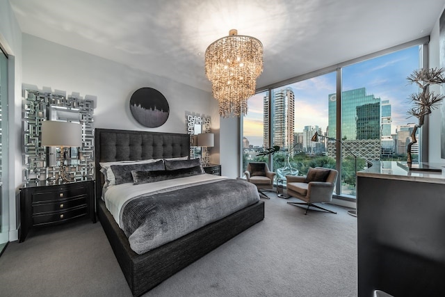 bedroom with carpet flooring, a wall of windows, and a notable chandelier