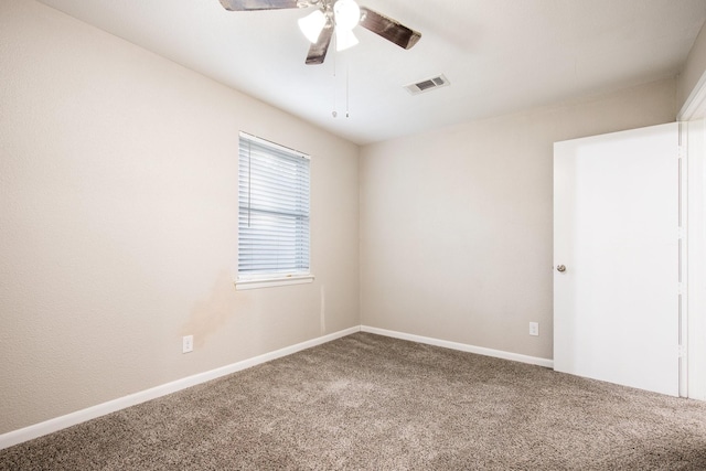 carpeted empty room featuring ceiling fan