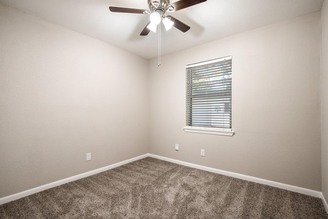 empty room featuring ceiling fan and carpet