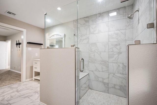 bathroom featuring vanity and a shower with door